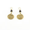 Handmade gold brass earrings in the shape of spirals, decorated with wooden beads. Designed and made in Egypt by Sami Amin.