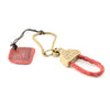 Handmade gold brass keychain with braided leather in red. 