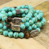 An Egyptian inspired sterling silver centerpiece accentuates a handcrafted stretch bracelet with semi-precious turquoise beads, decorated with a tiger eye bead as a symbol of courage, strength, and power.