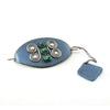 Handmade blue leather hairpin with gold brass spirals, decorated with glass circles. 